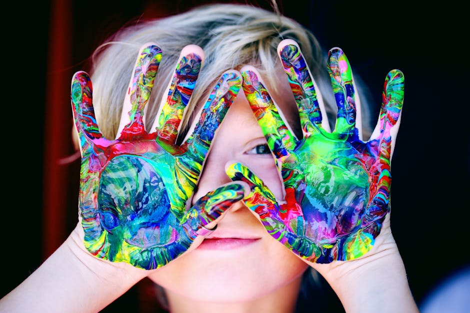 pexels-photo-1148998-1148998 Vibrant close-up of a child's hands covered in colorful paint, expressing creativity and fun.